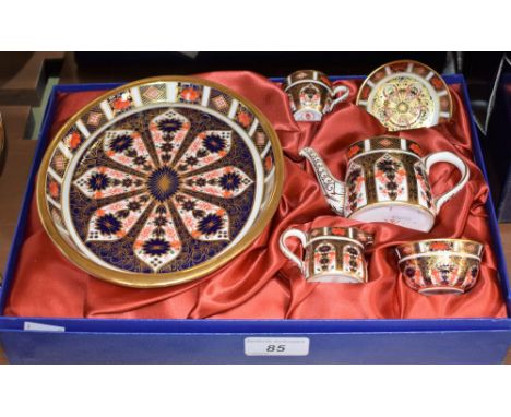 A Royal Crown Derby 1128 pattern miniature tea service, comprising tray, teapot, milk jug, sugar bowl, cup and saucer, first 