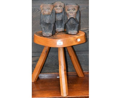 A novelty set of three carved hardwood wise monkies, See No Evil, Hear No Evil and Speak No Evil; a carved tripod stool, poke