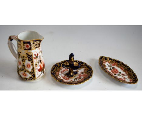 A Royal Crown Derby 2417 pattern cream jug; a Royal Crown Derby 2649 pattern ring stand; a similar trinket dish, all first qu