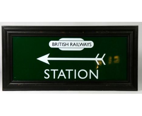Framed green and white British Railways 'Station' sign with left pointing arrow. Dimension of the glass are 49.5cm x 19cm. We