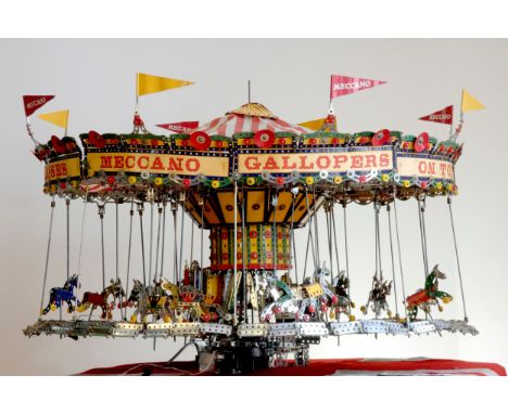 A Meccano shop display, 24 horse carousel, balanced on an electric motor including lights (not functional), sounds and dummy 