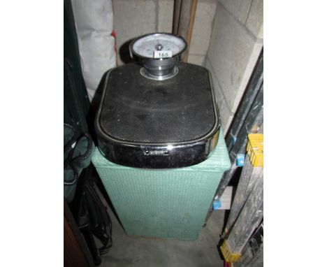 A linen bin and bathroom scales,.