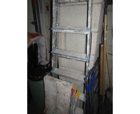 An aluminium step ladder and a work bench.