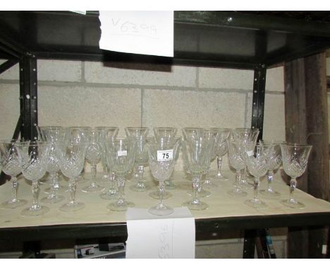 A shelf of assorted glass ware.