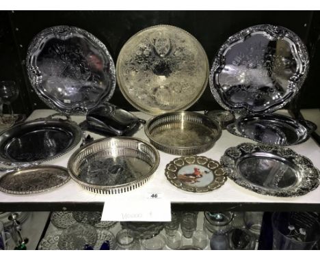 A shelf of silver plated trays etc.,