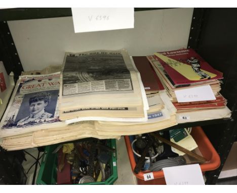 A shelf of old newspapers and magazines.