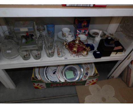 A shelf and a box of commemorative china, plates etc.