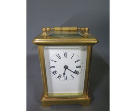A brass carriage clock - Height 12cm - clean working condition with key