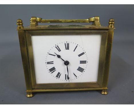 A brass cased carriage clock, white enamelled dial with Roman numerals to chapter ring, stamped France to back of movement, h