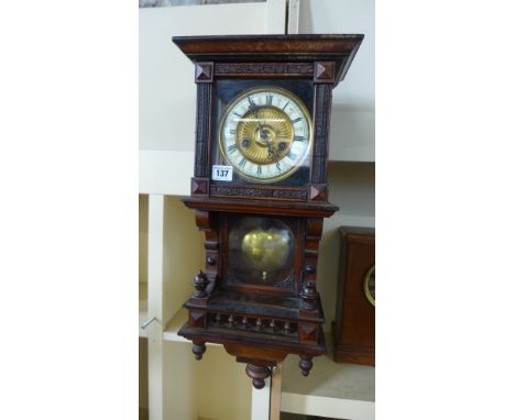 An eight day walnut wall clock - Height 60cm 