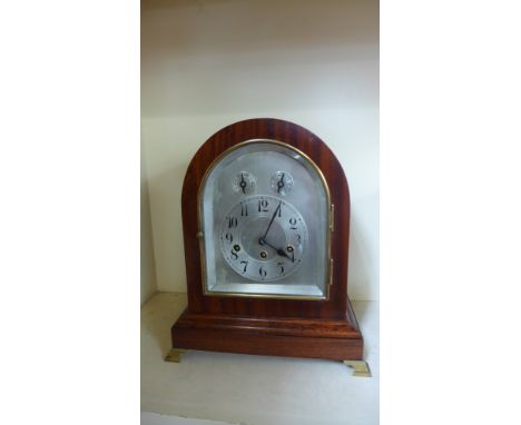 A Junghams mahogany chiming mantel clock, chiming on five rods with a silver dial - Height 36cm 