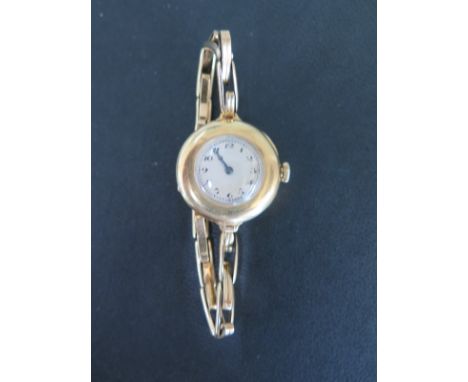 An 18ct yellow gold ladies wristwatch with sprung strap, manual wind, 28mm wide - not working - total weight approx 26 grams 