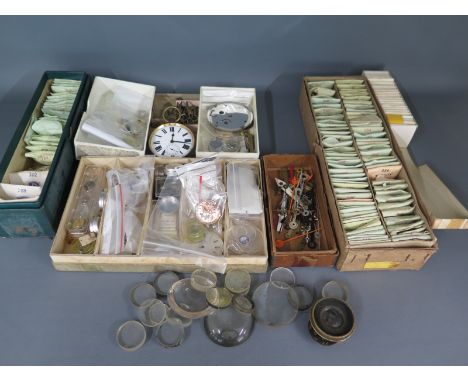 A selection of watch and clock parts including watch glass faces, clock hands, pocket watch parts, keys, watch faces etc