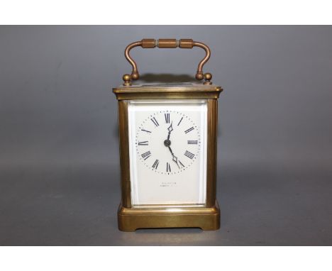 A late 19th early 20th century French carriage clock, stamped to the rear R & Co. made in Paris, full panel white enamel dial