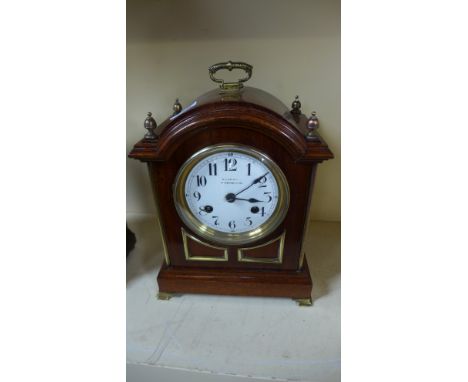 An eight day walnut case mantel clock, brass columns, brass OG feet, quarter chimes on two gongs - Height 30cm - Working 