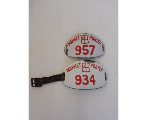 Two white enamel Market Porter armbands, with red lettering.
