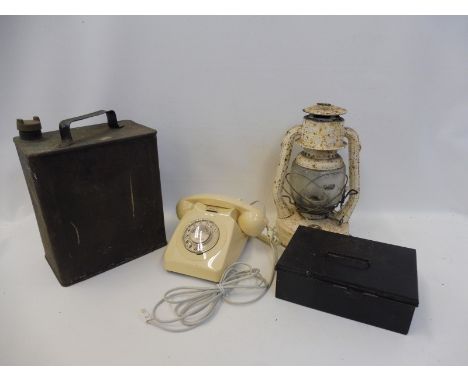 A white painted tilley type lamp, a two gallon petrol can and a Regalo first aid case. 