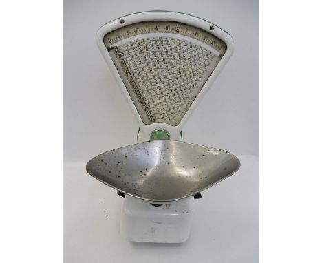 A set of white enamel and green embellished Avery shopkeeper's scales.