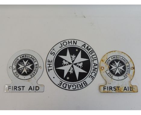 A St. John Ambulance Brigade circular enamel plaque and two smaller for First Aid.