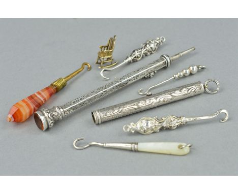 TWO EDWARDIAN SILVER RETRACTABLE PENCILS, FIVE BUTTON HOOKS AND A CHARM, the retractable pencils with engraved scrolling foli
