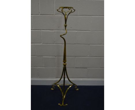 A LATE 19TH CENTURY ART NOUVEAU BRASS STAND, the circular top on a twisted upright and a shaped tripod legs, approximate heig