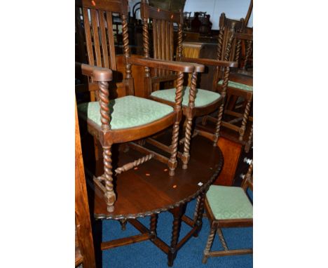 AN OAK OVAL TOPPED BARLEY TWIST GATE LEG TABLE, with pie crust edging, together with six barley twist chairs with drop in sea