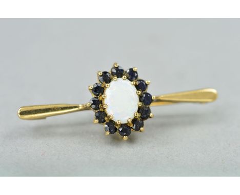 A 9CT OPAL AND SAPPHIRE BROOCH, the central opal cabochon within a sapphire surround to the tapered bar brooch, hallmarked Bi