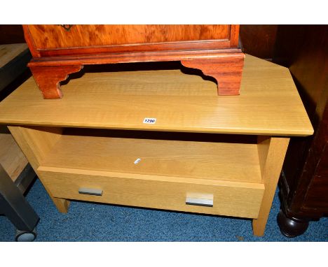 A LIGHT OAK CORNER TV STAND, with a single drawer