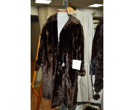 A SEAL FUR FULL LENGTH COAT, with valuation receipt from 1970, together with a faux fur animal print coat, a raincoat (Dannim