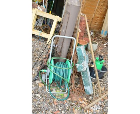A WOODEN HALF RAKE, hose reels, a cast iron bench ends with supports, and a quantity of garden tools (over 10)