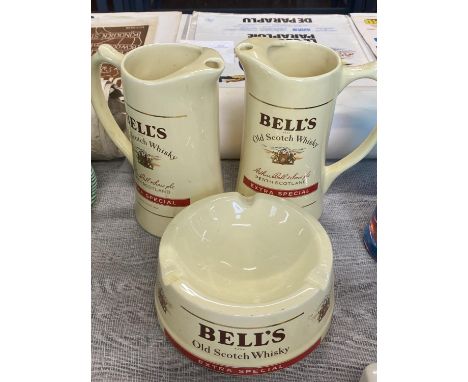 Two Bell's whisky water jugs and a ceramic Bell's whisky ashtray, all made by Wade 