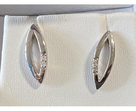A pair of silver and diamond earrings 