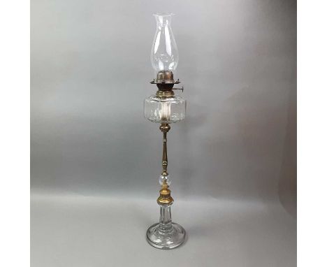 VICTORIAN BRASS OIL LAMP LATE 19TH CENTURY with clear glass chimney and faceted reservour, over a ring turned brass column wi