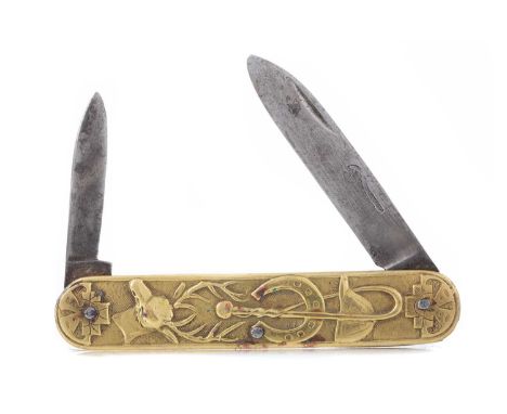 BRASS PENKNIFE LATE 19TH/EARLY 20TH CENTURY decorated with a fox, deer, cap, horse shoe, marked with a spanner to one of the 