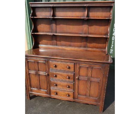 Ercol dining suite comprising of dresser with two tier raised back, four central drawers and two cupboard drawers, and a draw