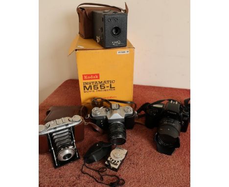 Quantity of various cameras and camera equipment in one box including a Zenit-B with case, a boxed Kodak Instamatic Projector