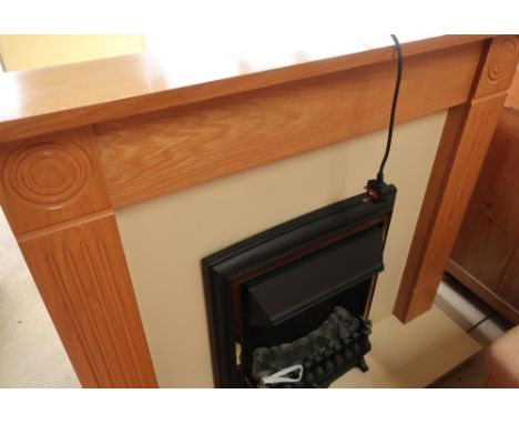 Modern electric fire with painted hearth and light oak surround 