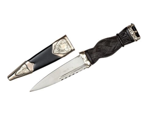 A small silver mounted skean dhu, blade 3½”, darkwood hilt with strapwork outer face, facetted dark stone pommel in Celtic st