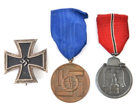 A Third Reich East Front medal, with ribbon; also a 1939 Iron Cross 1st class, of one piece non magnetic construction, and an