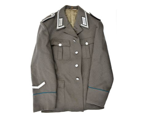 A post war East German officer’s tunic, with “Grenztruppen Der DDR” cuff title and matching trousers; and similar NCO’s tunic