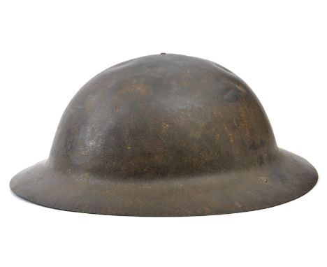 A WWII Brodie’s pattern steel helmet,  with part of chinstrap and liner. Basically GC for age (some pitting inside, minor den