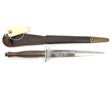 A Third Pattern FS military knife, blade etched on one side with crowned R Arms and suppliers with motto, ribbed grip, in its