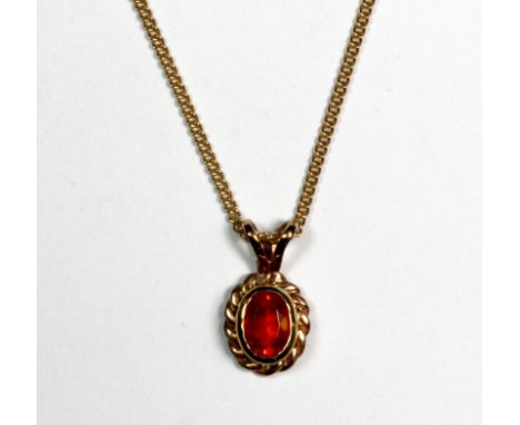 A 9ct Welsh yellow gold pendant set with a fire opal on a 9ct gold chain.