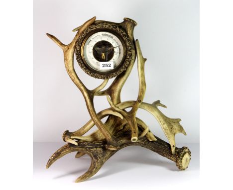 A 1920's German Black Forest barometer with antler frame stand, H. 42cm.