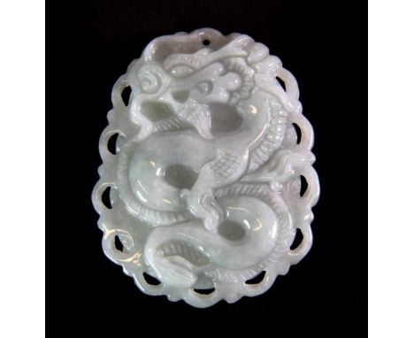 A finely carved Chinese pale celadon jade dragon amulet, L. 5cm.