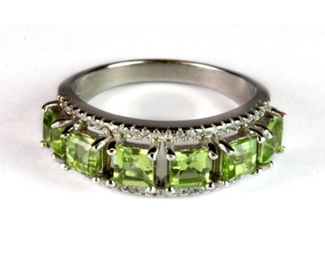 A silver peridot set ring (R.5).