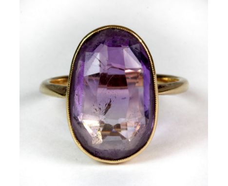 An 18ct yellow gold ring set with a large amethyst (R).