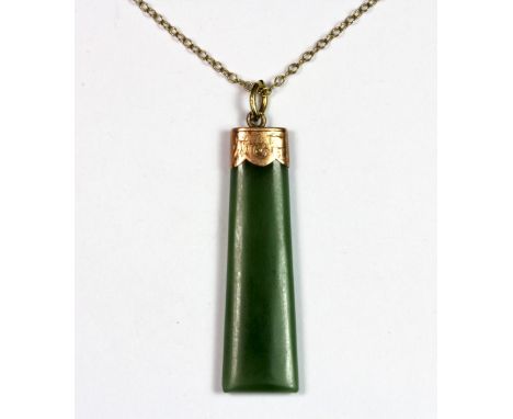 A 9ct gold mounted jade pendant and 9ct chain.