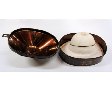 An early 20th century pith helmet by "Comfortease" size 6.3/4 with original tin hat box.