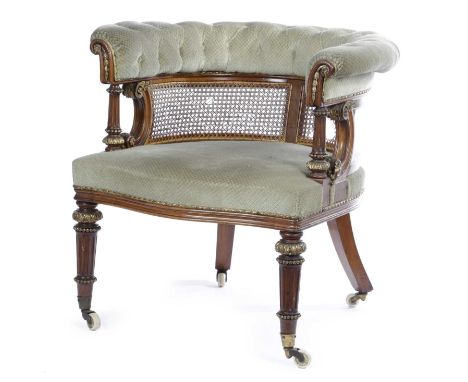 A VICTORIAN WALNUT AND ORMOLU MOUNTED DESK CHAIRIN THE MANNER OF HOLLAND & SONS, C.1860with a curved caned back, above a serp